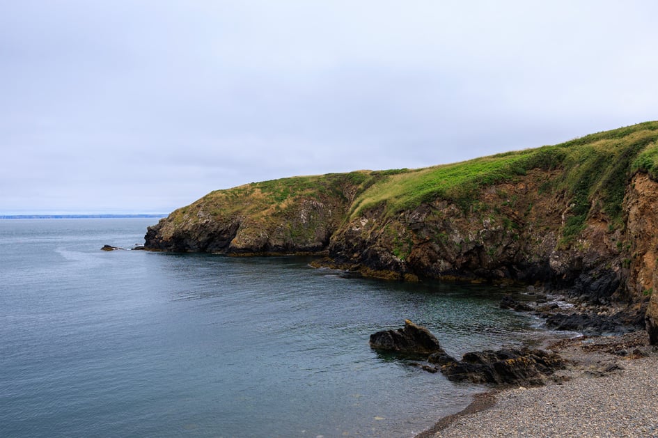 A quiet rocky cove near Martin's Haven with calm open sea views across Pembrokeshire