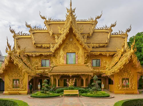 The intricate white spires of Wat Rong Khun under soft morning light in Chiang Rai, Thailand